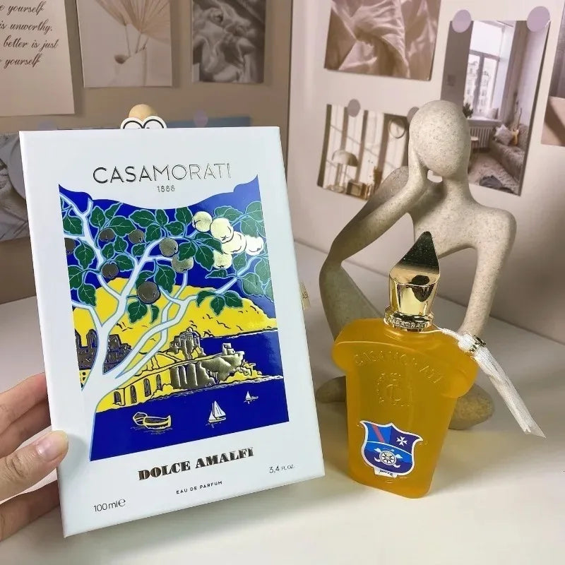 Casamorati Dolce Amalfi perfume bottle and packaging with decorative background