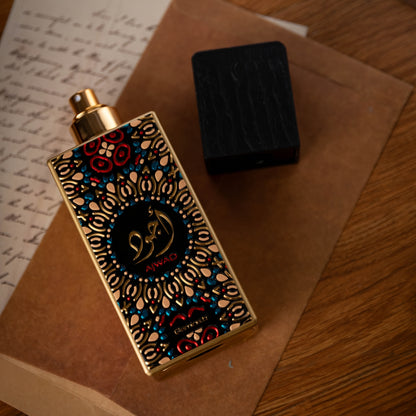 Decorative perfume bottle with intricate design on a wooden surface
