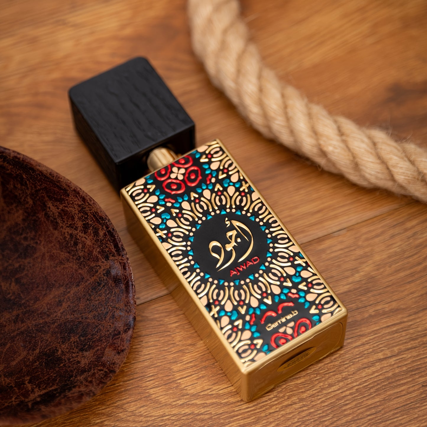 Decorative perfume bottle with intricate design on a wooden surface
