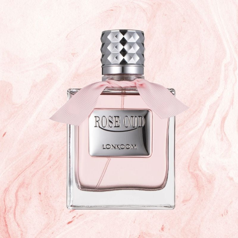 Perfume bottle labeled 'Rose Oud' by LONKOOM on a pink marble background