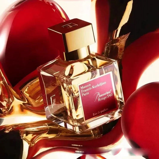 Perfume bottle with gold cap and red label on a reflective surface