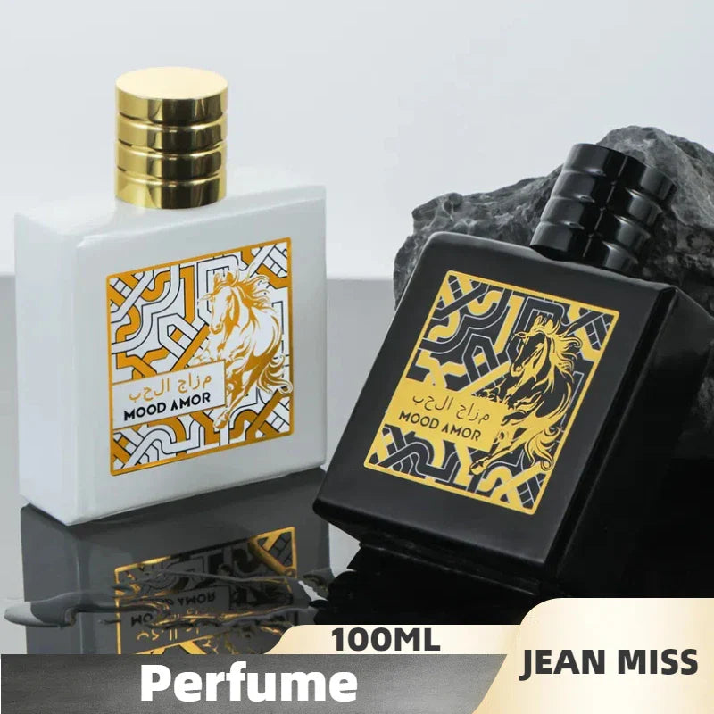 Two perfume bottles, one white and one black, with gold accents on a reflective surface.
